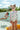 Girl wearing AZULEJO - WINGS LONGSLEEVE swimsuit with ruffles, posing by a pool on a sunny day.
