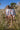 Two children wearing POLILLA ARCOIRIS CRUDO long sleeve swimsuits in a grassy field, showcasing stylish designs.