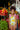 Girl in a banana print one-piece swimsuit with puffy straps at a vibrant fruit market.